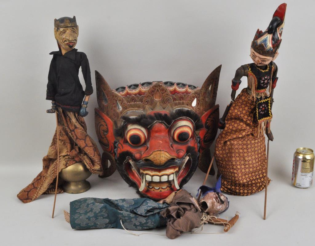 Group Indonesian Puppets & Painted Mask: comprising two rod puppets on makeshift stands, with carved and painted wooden head and arms, together with a marionette and demon mask. The largest: 24 1/2" high, the mask: 15" high, 16" wide. Wear, 