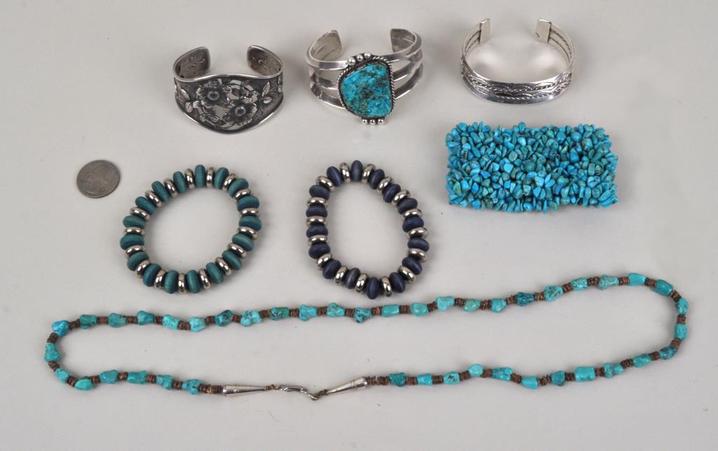 Group Silver/Turquoise & Other Jewelry: comprising a large Navajo turquoise cuff and smaller row cuff; a repousse' rose cuff; three silver, wood and turquoise stretch bracelets; and a turquoise necklace. Weighable silver 2.285 ozt. Largest: