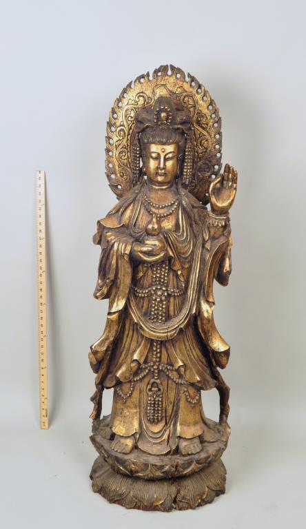Large Carved Giltwood Full Length Standing Guanyin: finely robed and jeweled figure with flaming mandorla and holding a double gourd vase, on a lotus carved base. 51" high, 18" wide, 15" deep. Several large shrinkage cracks. Provenance: Property of a N