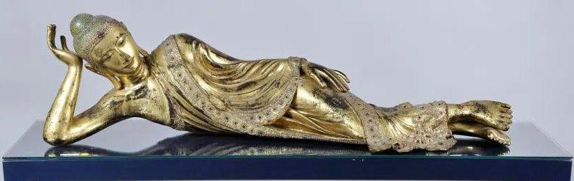 Burmese Carved Giltwood & Inlaid Reclining Buddha: Burmese carved, gilded, lacquered, "jeweled " and mother of pearl inlaid reclining Buddha, 19th century. 13 1/2" high, 46" long, 17" deep. Gilt wear, loss, age cracks, small losses, old repairs. Prope