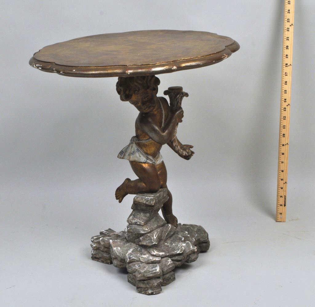 Venetian Carved Giltwood Rococo Style Table: lobed top with polychrome putti supporting column, footed rockwork base. 23" high, 20" diameter. Age appropriate wear. Provenance: Property of a New Haven County Collector.