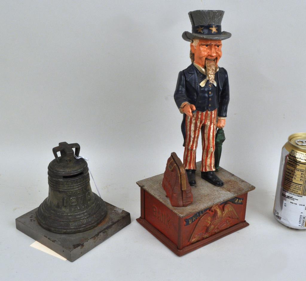 Two Cast Iron Patriotic Banks: a centennial Liberty Bell still bank and an Uncle Sam mechanical bank. The larger: 11" high, 4 1/2" wide, 4" deep. Uncle Sam bank lacking door and key, wear and surface losses to both. Provenance: Pro