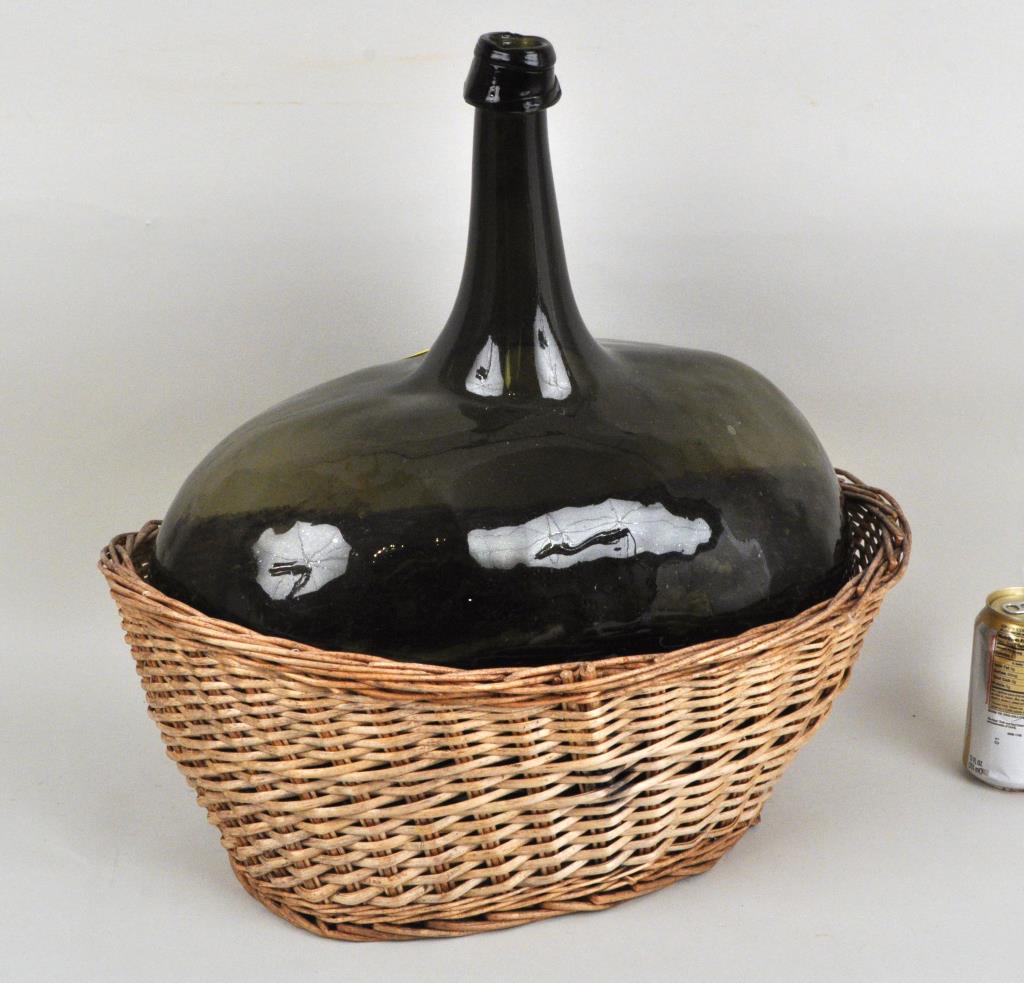 Hand Blown Green Demijohn Bottle: with mottled surface, strapped mouth. 20" high, 17" wide, 10 1/2" deep.