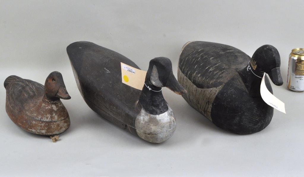 Three Swimming Goose Decoys: likely early 20th century. The smallest signed "WJC". Largest: 9" high, 20 long, 7" wide. Shrinkage cracks to one, wear from use throughout. Provenance: Property of a Woodbury CT Estate.