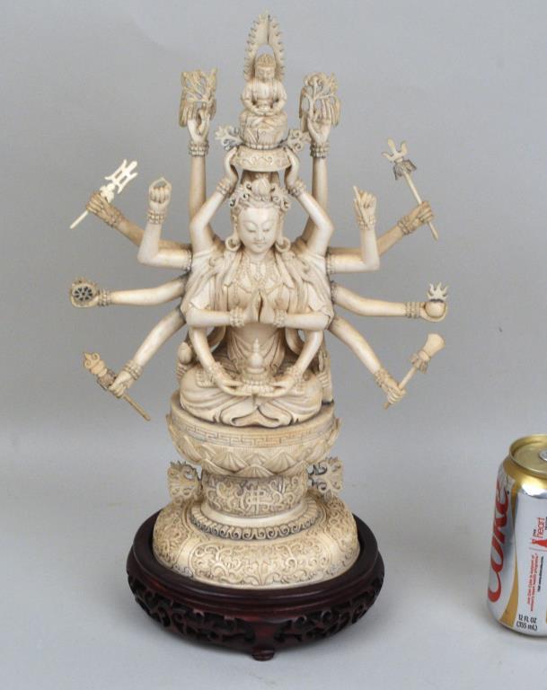 Carved Figure of Seated Cundi Avalokiteshvera: the 18 armed Bodhisattva holding various attributes and supporting a figure of Buddha Amitabha, on a lotus base raised on a carved pedestal, signed underside. 14 1/2" high, 9 1/2" wide, on 4 1/2" high
