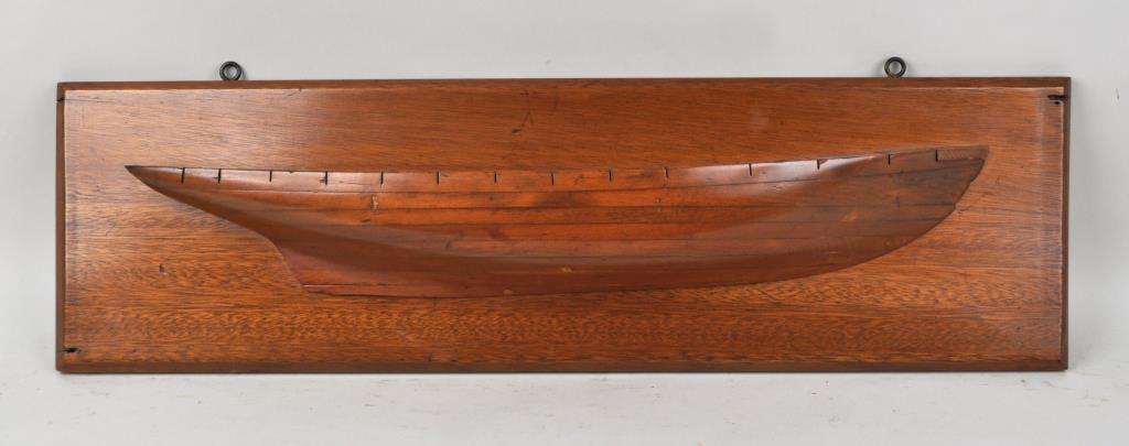 Wooden Ship Builder's Half Hull: schooner, pine model on hardwood board, lines cut out on deck. 34 7/8" long, 10 5/8" high, approximately 4 1/4" deep. A few gouges, scuffs, nail holes to upper right and lower left. Provenance: Estate
