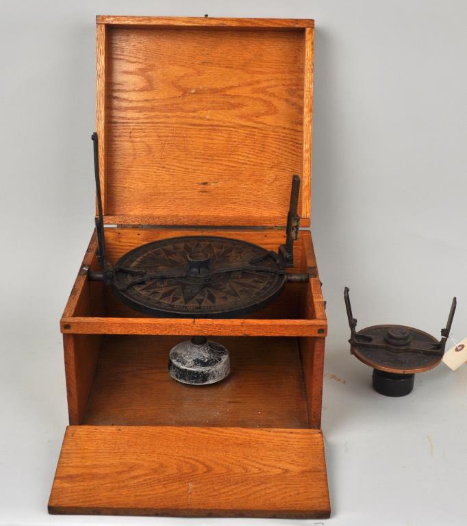 Group Two Pelorus Compasses: comprising WWII bronze and cast iron with metal tag: "Longines-Wittenaeur Watch Co Inc...March 1942. Type- 41/2 in illuminated Pelorus". With Dominick & Haff New York compass in an oak box, branded "D