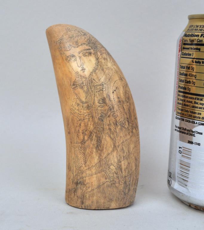 Scrimshaw Decorated Whale's Tooth: scrimshawed portrait of a woman. 4 1/2" high, 1 7/8" wide. Crack at base/side. We offer in-house packing and shipping of this item to an address in the United States for $45.00 via USPS Priority Mail.