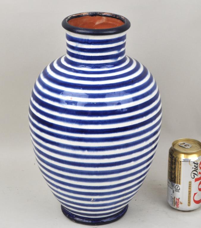 Moroccan Berber Glazed Earthenware Vase: baluster form with blue concentric banded infinity motif on a white ground. 14" high, 8 1/2" diameter. Wear to rim and underside of foot. Property of a Southbury CT Collector.
