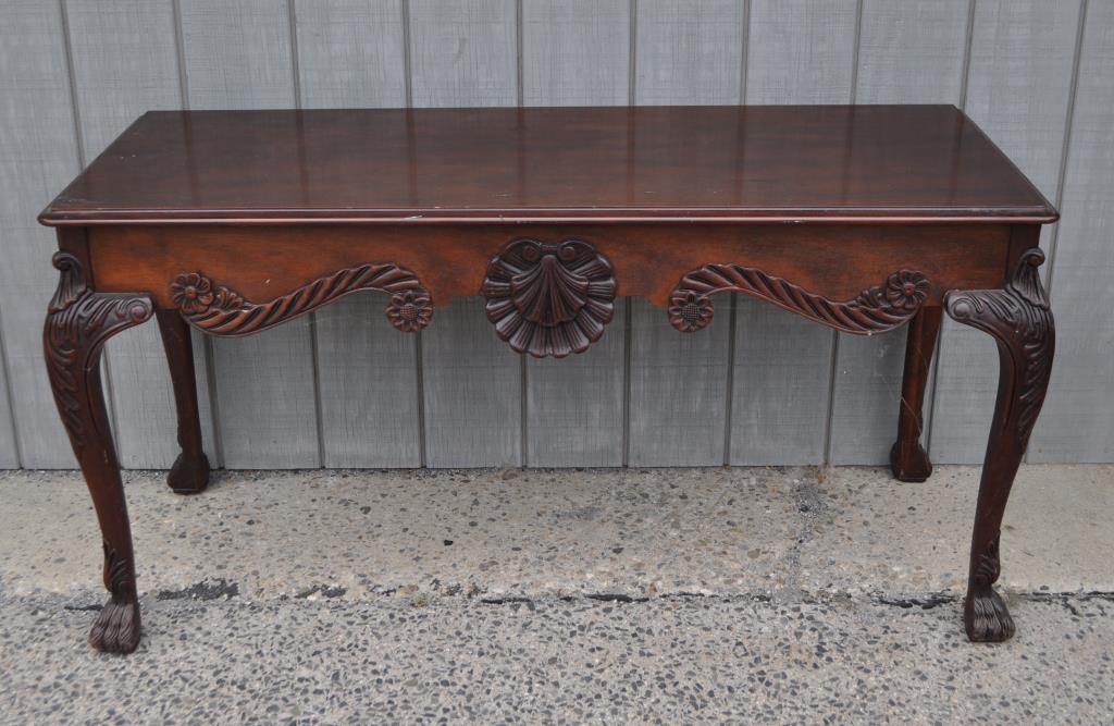 Baker Georgian Style Carved Mahogany Slab Table: with ornate shell design, paw feet, Baker tag underneath. Pictured p.167 de Dampierre "French Chic". 30" high, 58 1/2" long, 23" deep. Wear to top, moisture and bloom damage to finish. Provenance: Pro