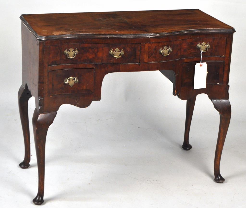 Queen Anne Style Walnut Ladies Dressing Table: with figured veneered top, serpentine front and carved cabriole legs. 30 1/8" high, 36" wide, 17 1/2" deep. Some veneer damage, staining, shrinking, minor losses, in estate condition. Provenance: Prop