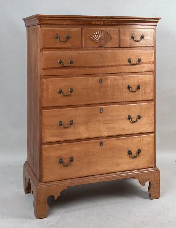 New Hampshire Fan Carved Birch Tall Chest: with molded top, fan drawer and lower graduated drawers. 50 3/8" high, 38" wide, 18" deep. Missing escutcheon, use wear, refinished, later base. Provenance: Property of a CT Collector