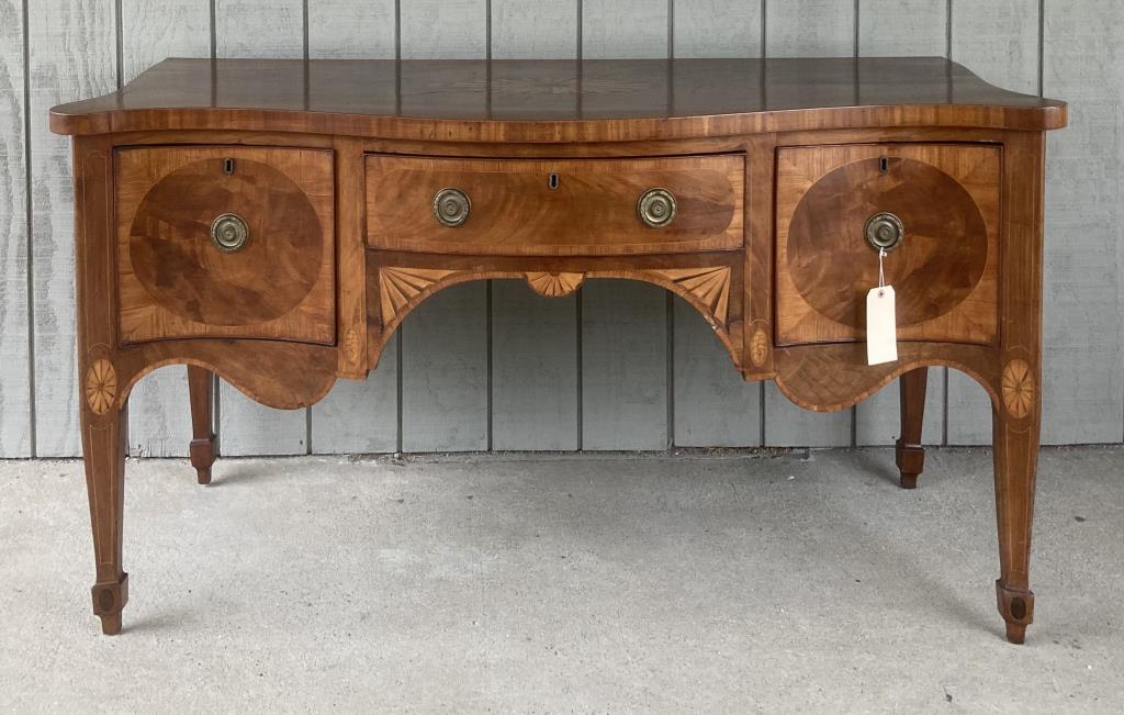 George III Inlaid Mahogany Serpentine Sideboard: shaped front and sides, heavily inlaid with banding, string inlays, oval paterae in top, paterae and other inlaid details on legs, mitered veneer drawer fronts. 33 1/2" high, 66" long, 29 1/2" deep. A