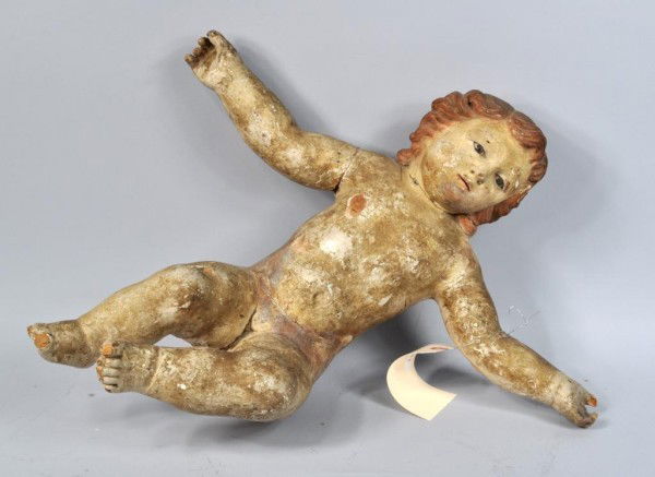 Carved Wood & Polychrome Putto: Carved wood and polychrome putto with glass eyes, Continental, 18th century. Losses and wear consistent with age. 19" high, 20" wide, 9" deep