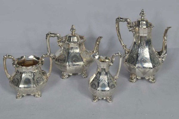 Four Piece Sterling Silver Tea Set, 19th C.: Sterling silver partial tea service, comprising coffee pot, teapot, creamer, and double handled open sugar basin, lobed form, with engraved oval reserves centering alternating butterflies and monogram