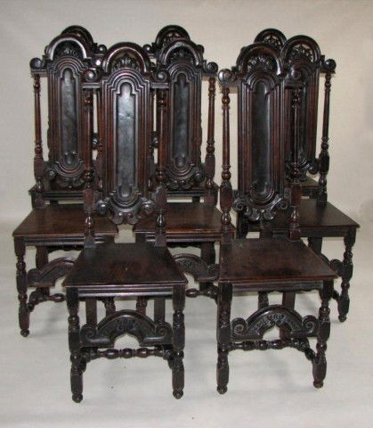 Set of 8 Carved Walnut High Back Chairs: Set of eight carved walnut baroque style high back chairs, molded arched crest with scrolled terminals centering a pierce carved foliate lunette above a deeply molded slender paneled back flanked by t