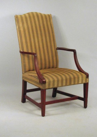 Federal Style Lolling Chair: Hepplewhite style, carved mahogany lolling chair with carved arms and molded front legs. American, 20th century. Replica of period lolling chair in Museum of Fine Arts, Boston. 43" high, 26" wide, 22"