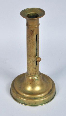 French Brass Candlestick, 19th C.: French round base push up candlestick, 19th c. 8 1/2" high, 4 1/2" diameter (base).