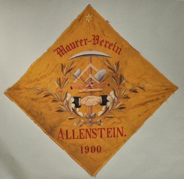 Masonic Embroidered Panel: Masonic embroidered panel, diamond-shaped panel of gold silk damask embroidered with Masonic iconography and the motto "Maurer-Derein, Allenstein 1900" 57" wide, 57" high. East Prussia (now Poland), c