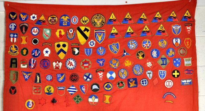 Nazi Flag, US Military Patches: Nazi flag with multiple (100+) United States military patches applied. 52" high, 88" long.