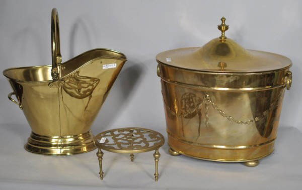 Group of Three Brass Items: Group of three vintage brass items, including a lidded kindling bucket, a watering bucket and a trivet. 17" high, 17" wide, 14" deep (kindling bucket); 18" high, 15 1/2" wide, 10" deep (watering bucke