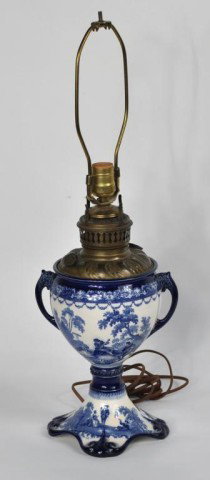 Porcelain and Brass Fluid Lamp: An interesting porcelain and brass fluid lamp, the brass lamp fitting into the rimmed opening of the porcelain vasiform base. 25" high, 9" diameter. (KJ-don't count lighting apparatus)