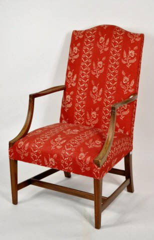 Hepplewhite Style Mahogany Lolling Chair: Hepplewhite style carved mahogany lolling chair, with shaped crest and upholstered back, with serpentine arms above carved and molded sloping arm supports, raised on square, tapering molded legs with 