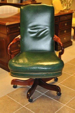 Leather Upholstered Executive Desk Chair: Executive leather desk chair in Queen Anne style, with crook arms and swivel base. 42" high, 25 1/2" wide, 25 1/2" deep.