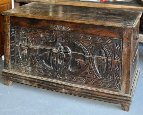 Provincial Carved Walnut Coffer: Provincial carved walnut coffer, of considerable size, the front with gouge carved nativity scene flanked by saints, with molded base on stile fee, French, early 18th century. 31" high, 52 1/2" wide, 