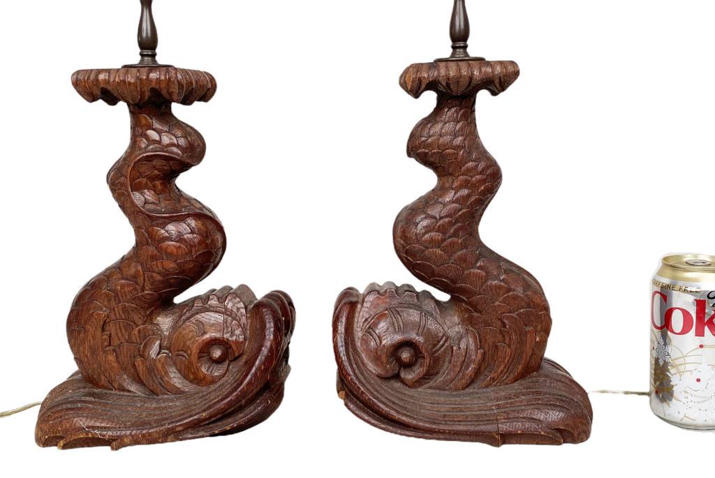 Pair Carved Wooden Dolphin Form Lamps: 25 1/2" high (11" high w/o harps), 5 1/2" wide, 8" deep. Small loss, light cracking. Estate of Adolph S. Cavallo.