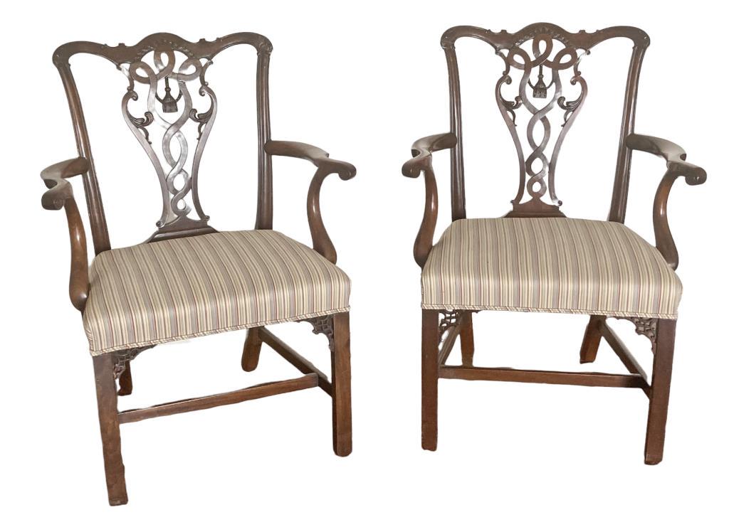 Pair Georgian Tassel Carved Mahogany Arm Chairs: fashioned of particularly dense and heavy mahogany. 38 1/4" high, 26 1/2" wide, 22 1/4" deep; seat height 18 1/2" high. One chair with old repair to crest joint and arm post. Property of a Greenwich C
