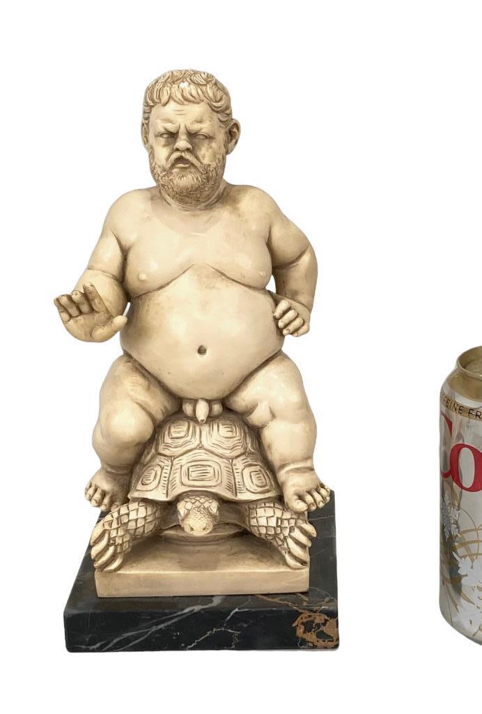 After G. Ruggeri, Italian Resin Statue: of a nude man riding tortoise. 9 3/4" high, 4 5/8" wide, 5 1/4" deep. Small nick on head. Property of a New York collector.