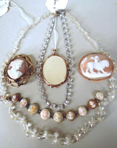 Three Gold Plated Items and Two Necklaces: Two gold plated shell cameo pins and a gold plated coral cameo bracelet, all late 19th C.; a yellow metal early portrait miniature frame; two necklaces, one paste 24" and one red stone 14".