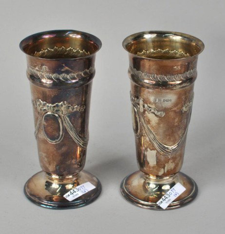 Pair Sterling Silver Vasiform Footed Beakers: Pair sterling silver vasiform footed beakers with garland and cameo decoration, marked for Joseph Rogers, Sheffield, 1899. 15.69 troy oz. 7 1/2" high, 3 3/4" diameter.