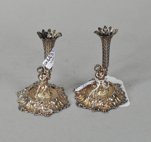 Pair Sterling Silver Repousse Figural Tapersticks: Pair of figural sterling silver tapersticks, marked for Walker & Hall, Sheffield, 1894. 2.64 troy oz. 4" high, 2 3/4" diameter.
