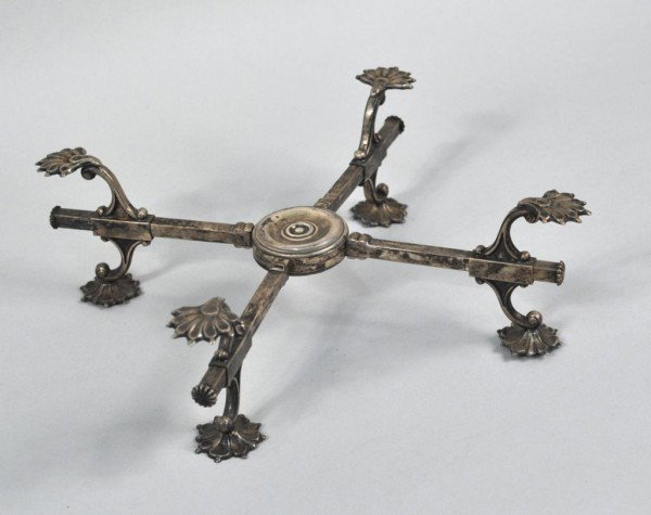 Old Sheffield Rococo Form Bowl Cross: Old Sheffield bowl cross of rococo form with four arms and typical sliding foot supports, probably England, late 19th century. 3" high, 13" diameter.