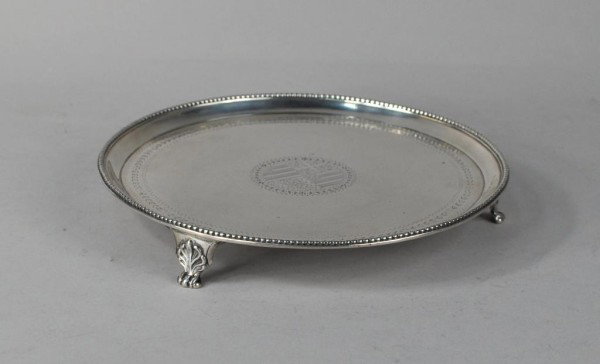 George III Silver Salver, London, 1779: George III silver salver, John Crouch and Thomas Hannan, London, 1779, circular with beaded rim, on three shellwork paneled feet, engraved with armorial within stylized borders. 12 troy oz., 8 1/4" lo