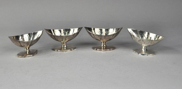 Set of Four George III Silver Salts, London, 1790: Set of four George III silver salts, Abraham Peterson, London, 1790, each of ribbed navette shape on pedestal foot, chased with flowers, foliage and shell work, having gilt interiors. 11 troy oz., 4 3