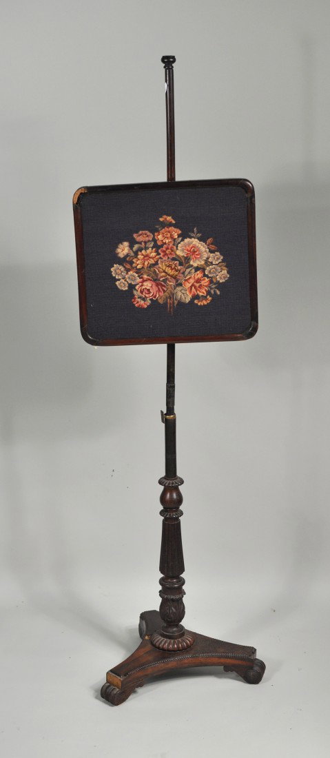 Regency Carved Rosewood Fire Screen, 19th C.: Regency carved rosewood fire screen, with rectangular molded needlepoint screen adjusting on a pole set in a turned reeded standard on a triangular plinth with bun feet. England, 19th century. 57" hig