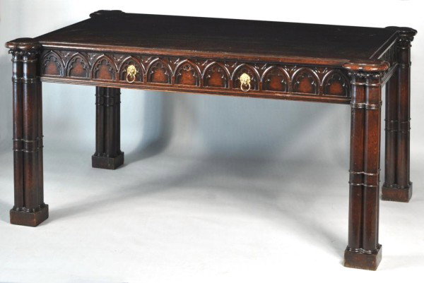 Georgian Style Gothic Design Writing Desk: Wonderful George III style gothic styled carved oak writing table, with two working drawers set within gothic carved apron, centered between cluster column gothic column legs. American, 20th century. 