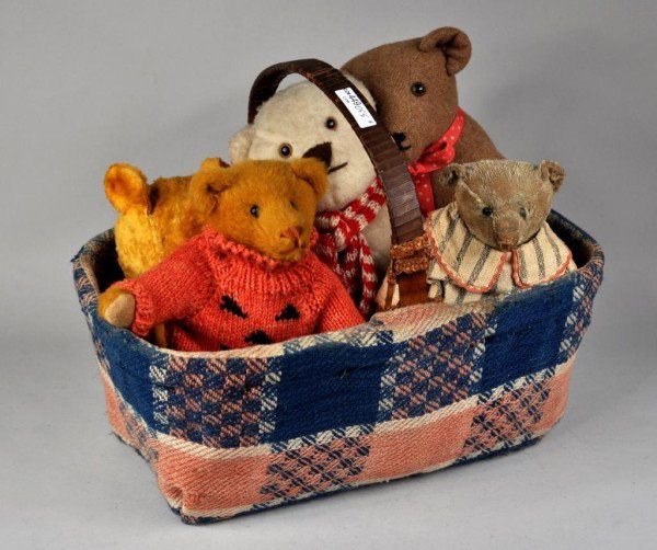 Five Vintage Teddy Bears in Basket: Appealing group of five vintage teddy bears of various sizes in a handled basket. Largest: 14 1/2" high, 12" wide. Smallest: 11" high, 10" wide.