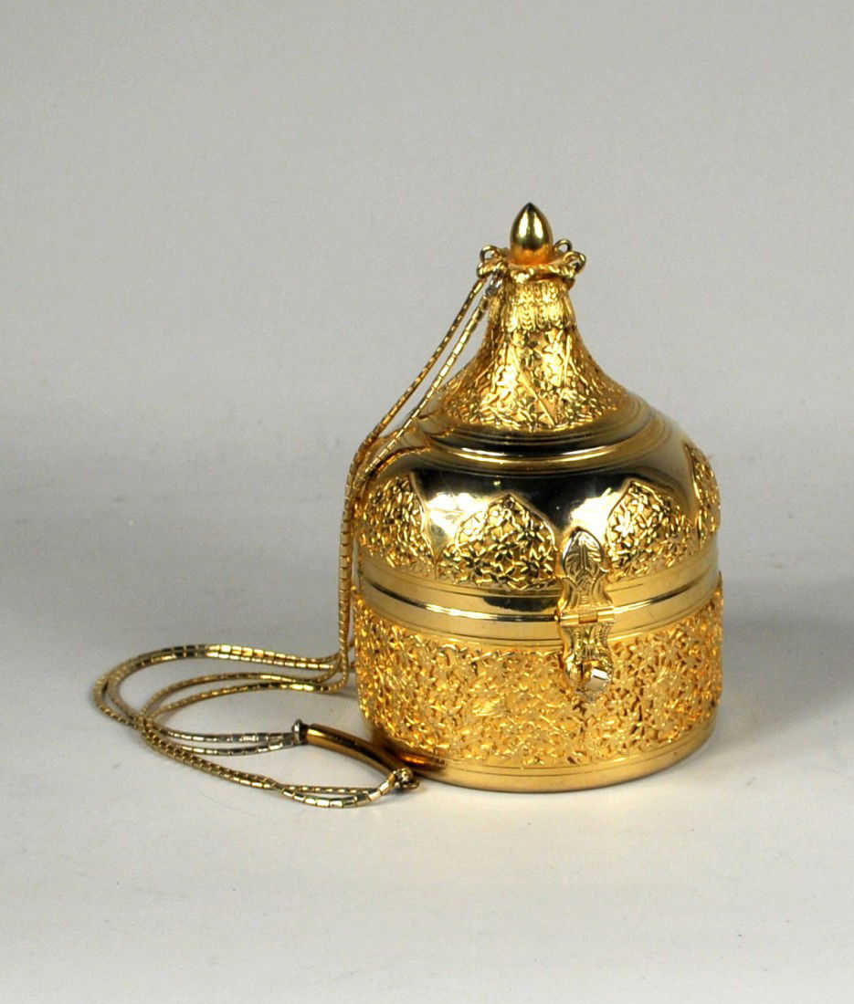 Judith Leiber, Minaudiere Form Evening Bag: Judith Leiber, evening bag, the gold domed brass minaudiere shaped like a Marakesh lantern with applied filigree to the base, lid and top, with a gold tone articulated chain, ca. 1980-1990. Some expec