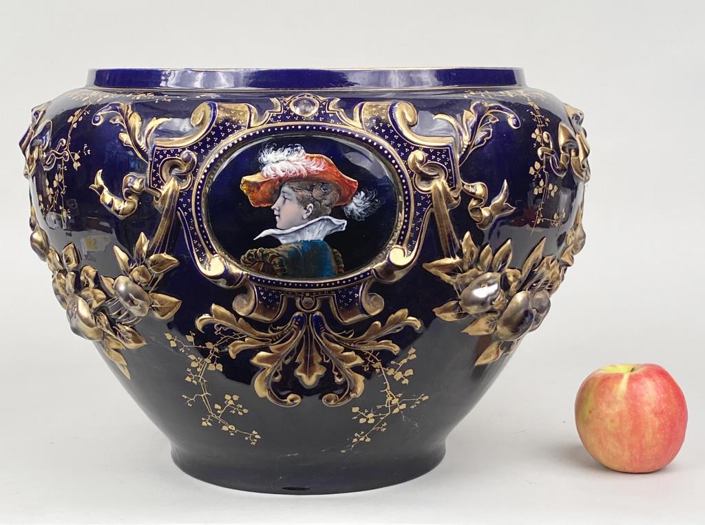 Large Edouard Gilles Barbotine Jardiniere: signed "E.G" and "33" in oval on bottom, also with partial old collection label. Limoges enamel on copper featuring a portrait of a youth in profile, gilt floral/fruit swag on cobalt ground, harp vers