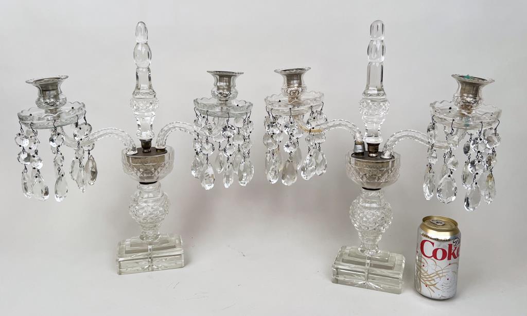Pair English Crystal Two Arm Lustres: in manner of Waterford. 17 1/4" high, 15" wide, 3 1/2" deep. Lacking wired components, one arm with repaired collar at base, two damaged crystals, one central cone with manufacturing defect. Property 