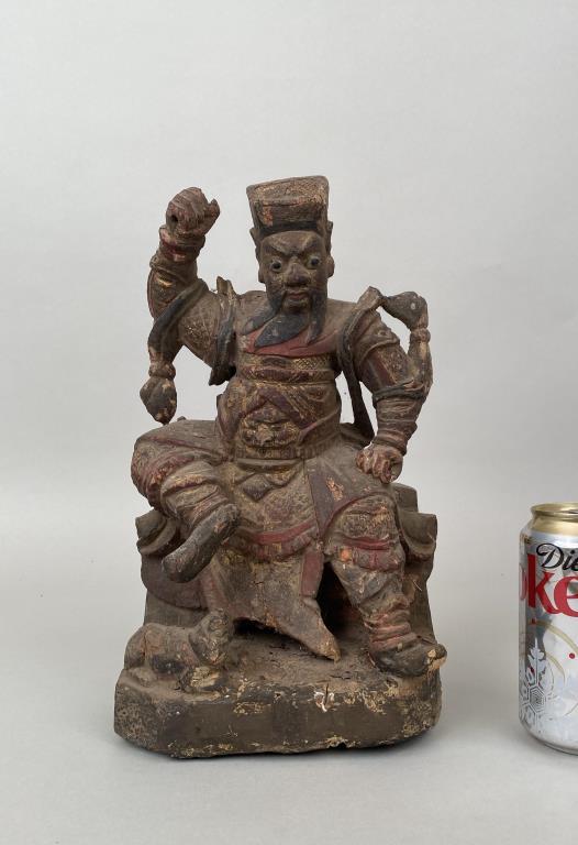 Chinese Carved Wood Parcel Gilt Figure Zhong Kui: the vanquisher and guardian in triumphant pose with sword raised (now missing); sealed prayer aperture verso. 12" high, 7" wide, 4 3/4" deep. Losses to painted and gilt surfaces, wear to base.
