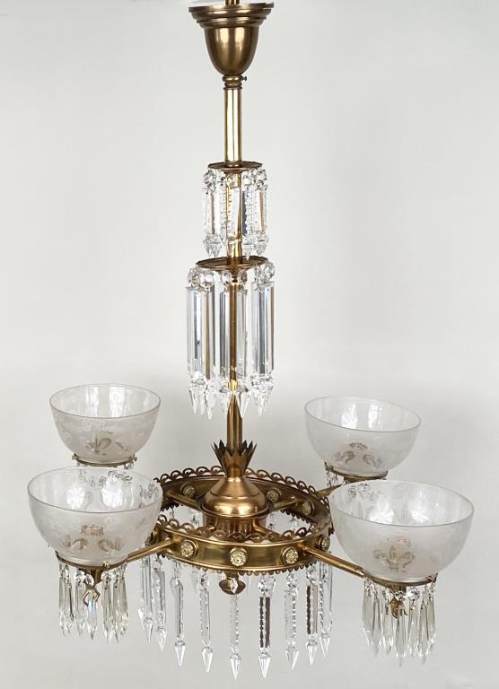 Classical Brass/Glass Four Light Chandelier: with prisms in two rows on shaft, circular on lights, gas lit style. 41" high, 31 1/2" wide, 31 1/2" deep. Bends in metal, some flicking to prisms.