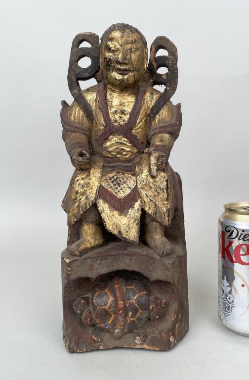 Chinese Carved & Gilded Seated Weituo: the temple guardian and protector seated over a base carved with the Black Tortoise with snake. 12" high, 5" wide, 4" deep. Losses to surfaces and figure as shown.