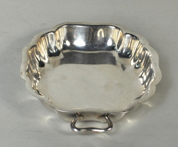 Sterling Silver Serpentine Shaped Handled Bowl: Sterling silver handled bowl with flared edge and multiple serpentine curves. 1 1/2" high, 10" wide, 7 3/4" deep. 17.65 troy oz.