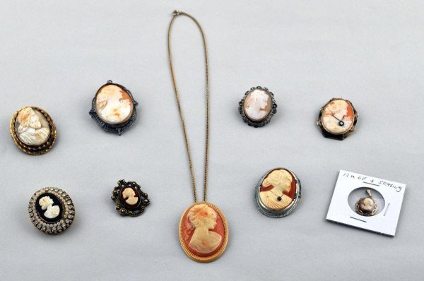Lot of Nine Shell Cameos - 10K and Sterling: Lot of nine cameos, including a fine 10K gold cameo habile with diamond necklace, large cameo pin/pendant in sterling silver, cameo pin with silver tone filigree setting, costume cameo necklace, cameo