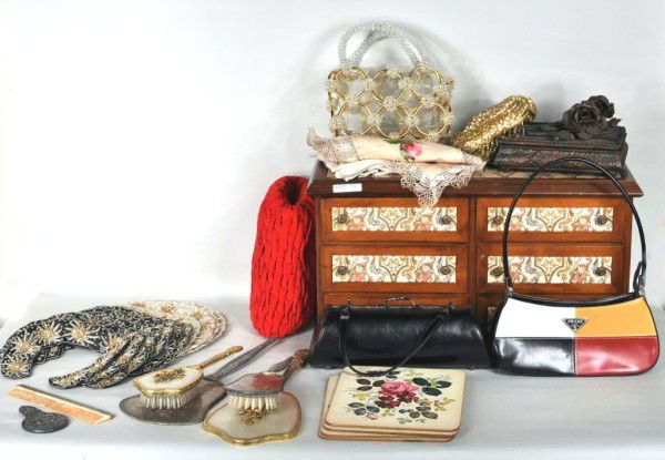 Dresser Set & Group of Miscellaneous Textiles: A set of six bedroom dresser set pieces, a tin box with rise decoration, one beaded collar, four handbags (one labeled Prada), muff, linens, handkerchiefs, 12 made in India beaded collars, four table